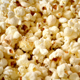 A close-up image of buttered popcorn.